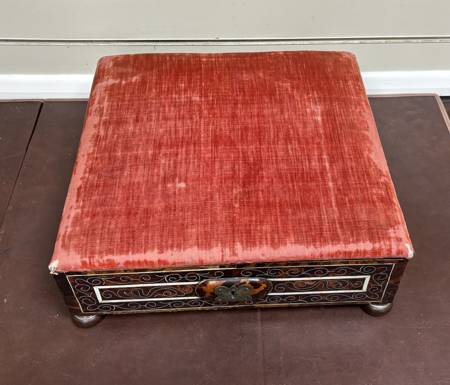 An 18th / early 19th century Portuguese tortoiseshell box with bone inlay and silk velvet lining with matching padded top, on bun feet, width 39cm, depth 38cm, height 16cm